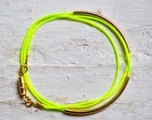 neon yellow super skinny nylon triple wrap bracelet with two long gold tube