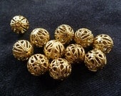 Bead, antiqued gold-plated brass, about 14mm beaded filigree round. Package of 11.