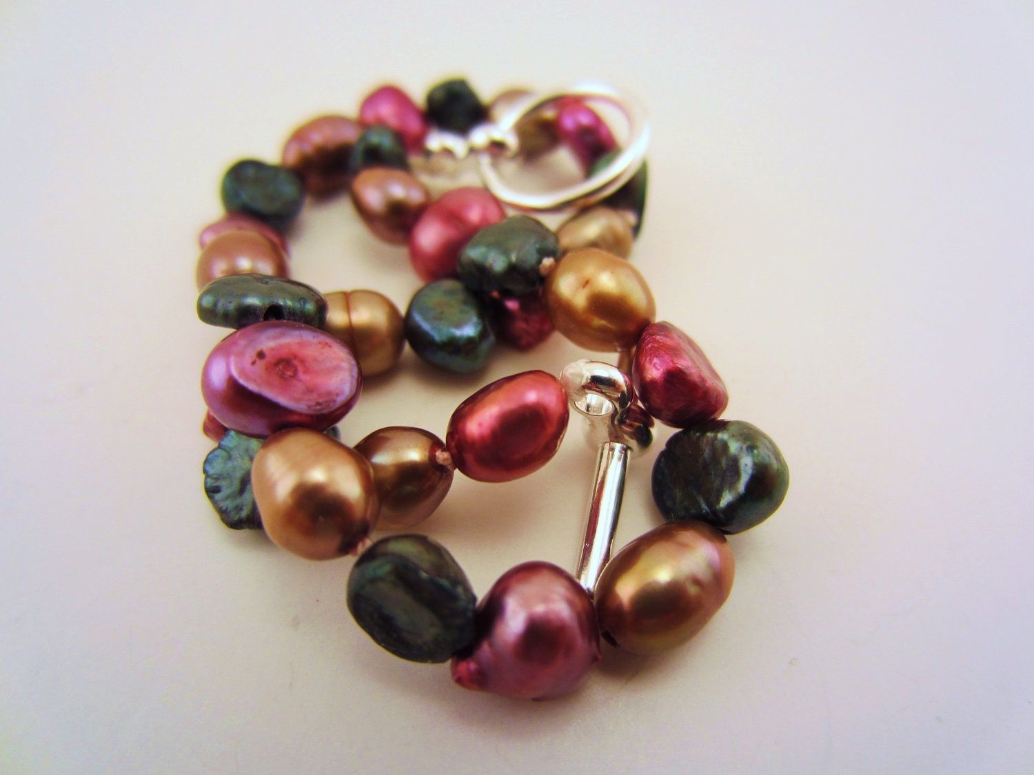 Multicolor pearl bracelet. Burgundy mix of genuine rice pearls. Silver plated toggle clasp. Hand knotted bracelet.  Champagne, black.