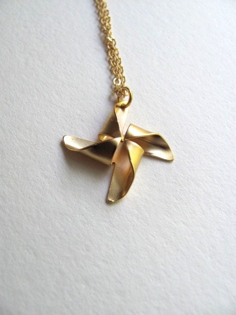 Petite gold pinwheel charm necklace on delicate 14k gold plate chain, satin matte finish