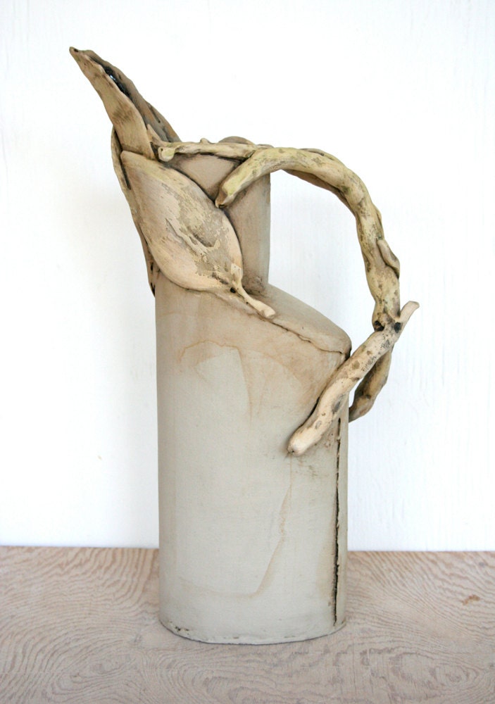Sculptural earthenware pitcher with leaves and twigs