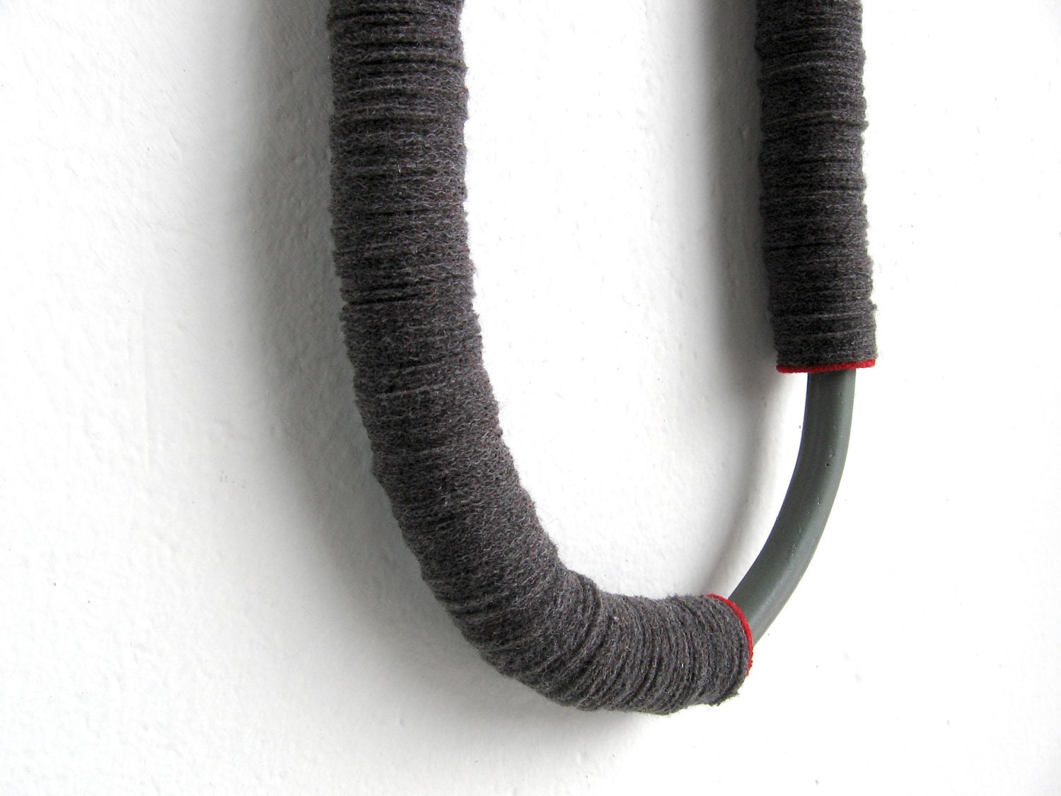 grey tube minimal geometric necklace with an arc ceramic bead and a red touch