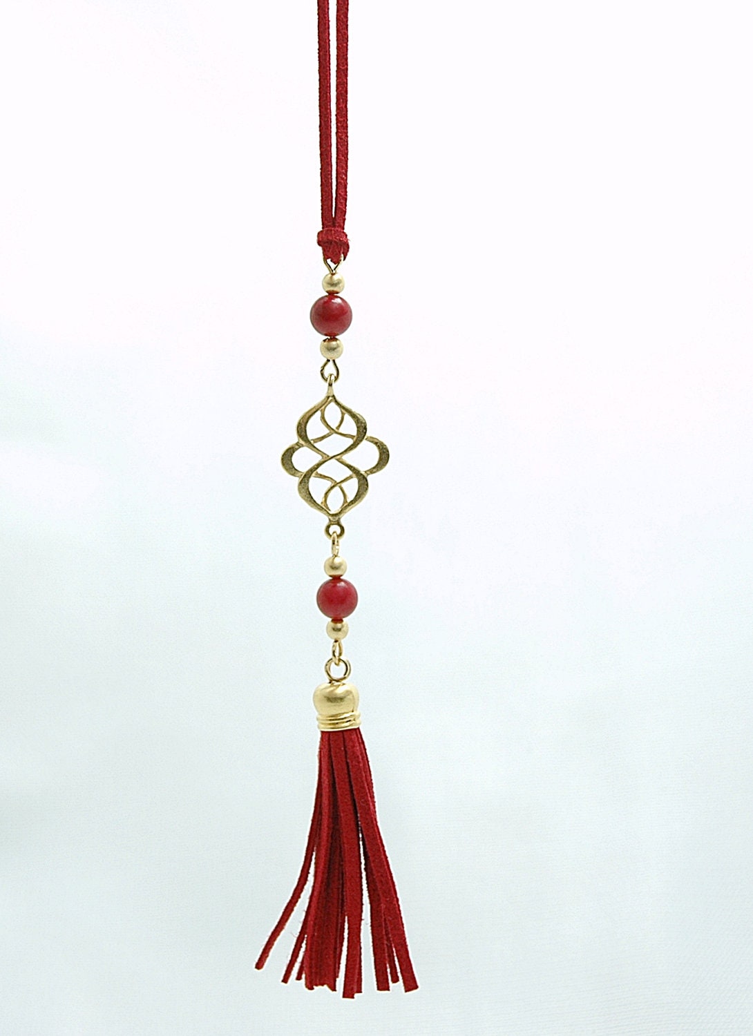 Gold Plated Oriental Infinity Charm Necklace with Red Coral Stones and Suede Leather Tassel
