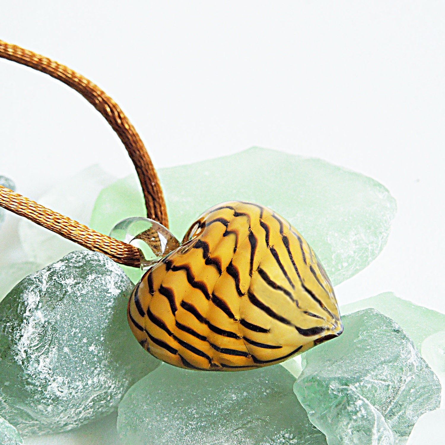Wild tiger heart pendant with silken cord