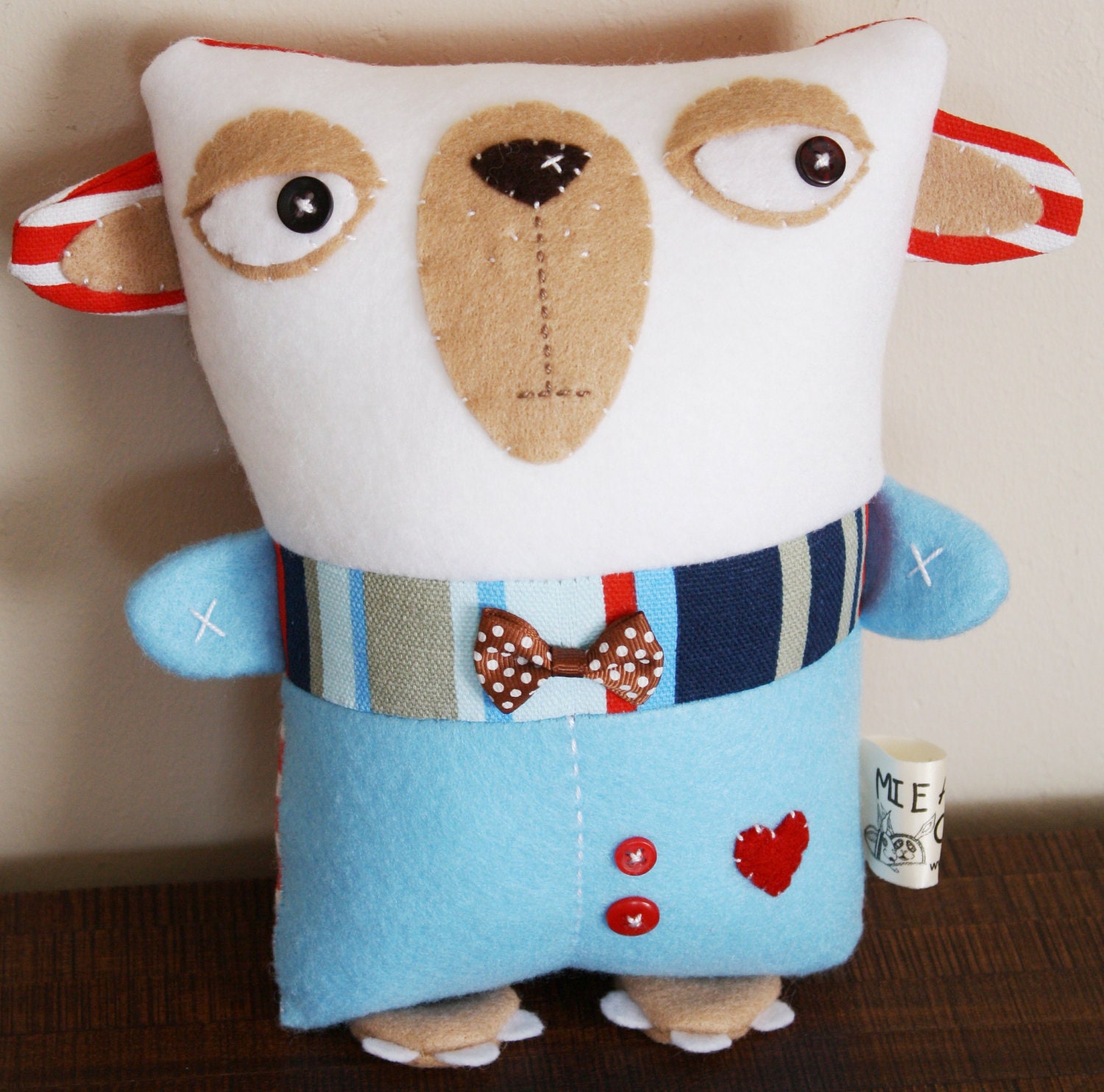 BOObeloobie Blakely the Bearling in Red, blue, cream and white with a bow tie and button detail for eyes.