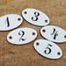 5 Oval French Enameled Tags, luggage tags, and labels