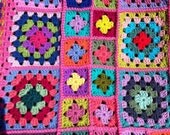 Crocheted afghan kaleidoscope granny squares with PINK border