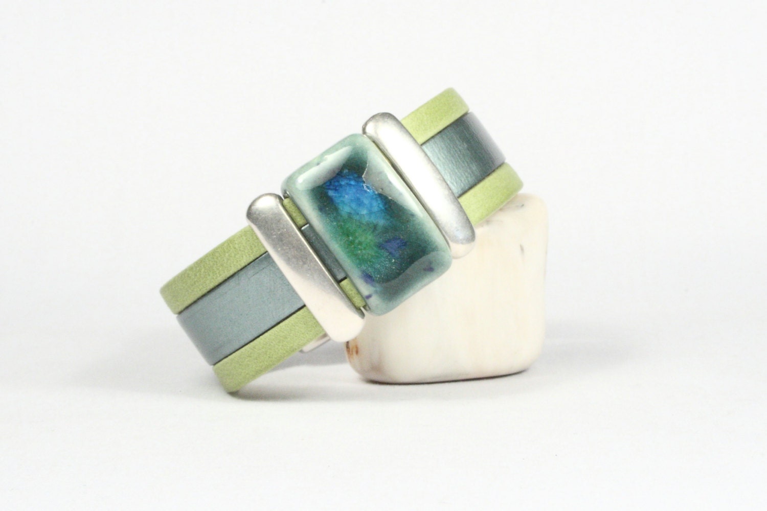 Cuff bracelet leather. Italian and Arizona flat leathers. Metallic aqua and lime green.  Porcelain bead.  Silver magnetic clasp and bars.