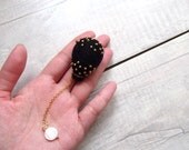 Felted brooch. Needle felted balloon brooch in Black, hand stitched Gold seed beads, Mother of pearl disc bead hangs at the bottom. B9