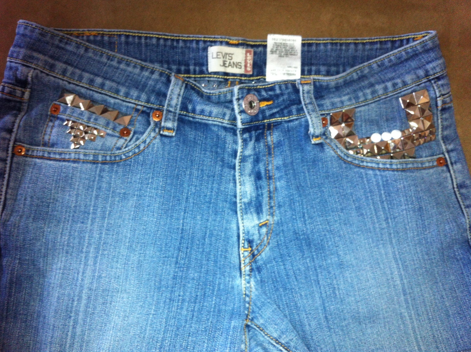 STUDDED and SPIKED Distressed Mid to High Waisted Faded Blue Denim Jean Shorts with Orange Stitching Pink Levis Patch Font Size 9S