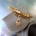 beige leater bracelets with gold filled hamsa pendant