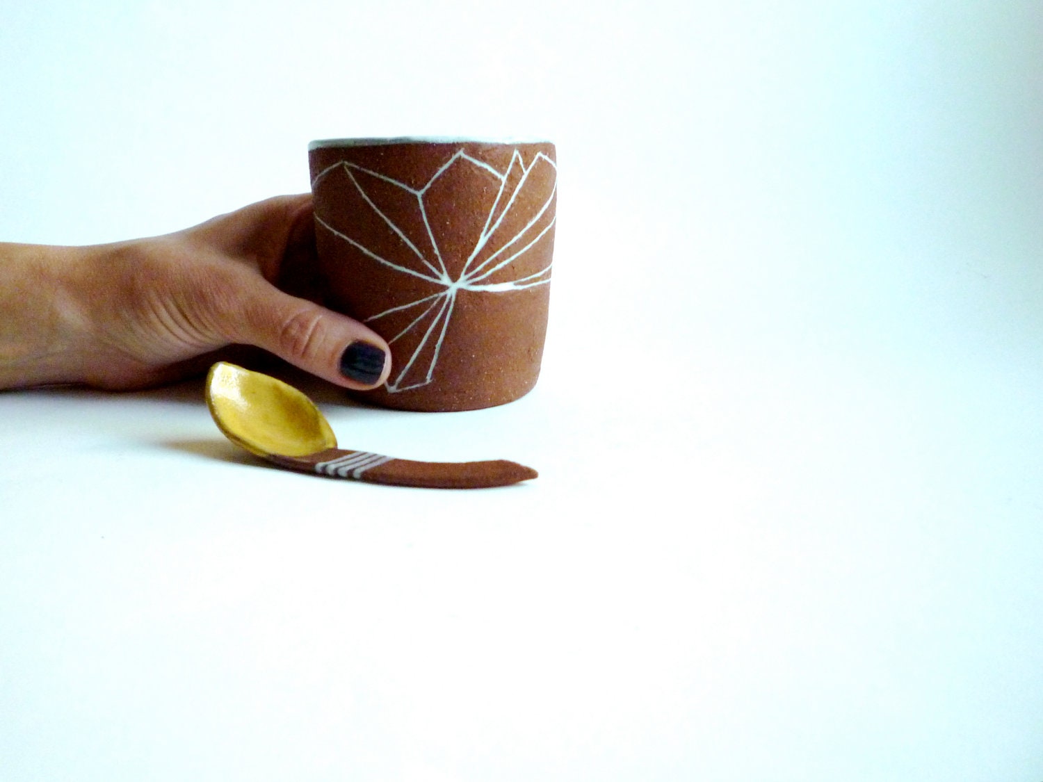 geo prism tumbler and yellow spoon