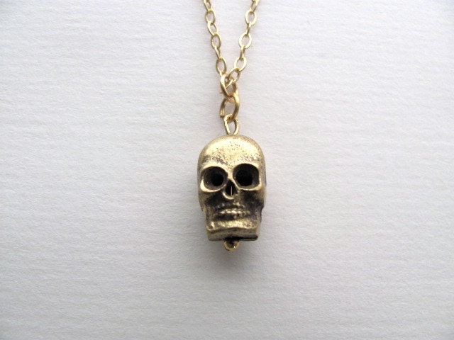 Gold skull charm necklace on delicate 14k gold plate chain, satin finish