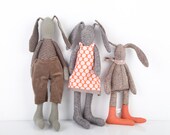 Easter bunny - mother father and child , he in Striped shirt and brown corduroy She in pink  dot dress the  boy with scarf and orange socks