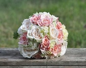Blush coral and pink roses and hydrangea wedding bouquet made of silk flowers.