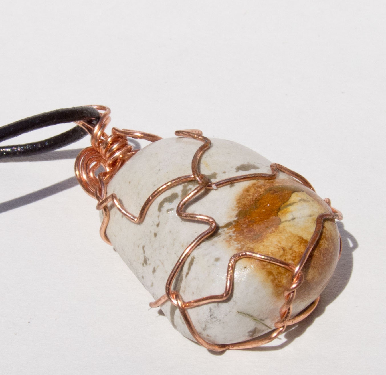Wire wrapped white and red and black beach stone pendant necklace