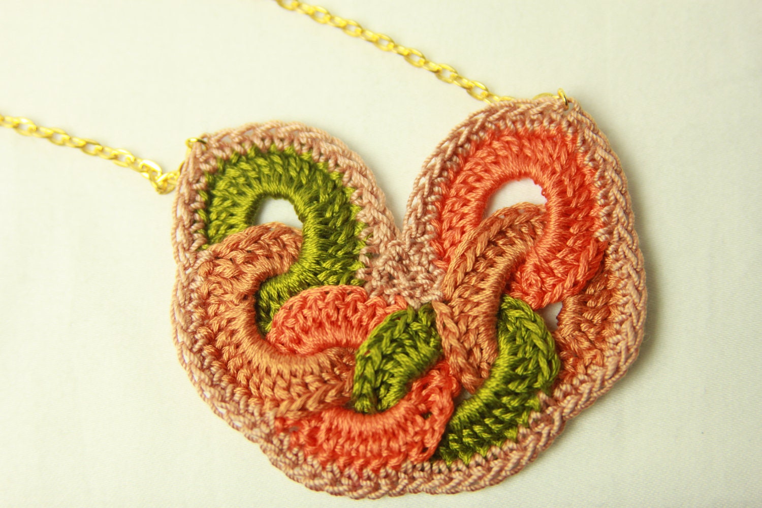 Textile necklace on a gold tone chain