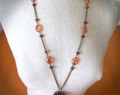 Aunt Autumn - Antiqued bronze/brass pendant necklace with a large maple leaf and strand with yellow/orange and copper faceted glass beads