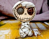 Baby mummy sculpture with vintage buttons in his eyes. Cute and creepy. Ideal for Halloween decoration
