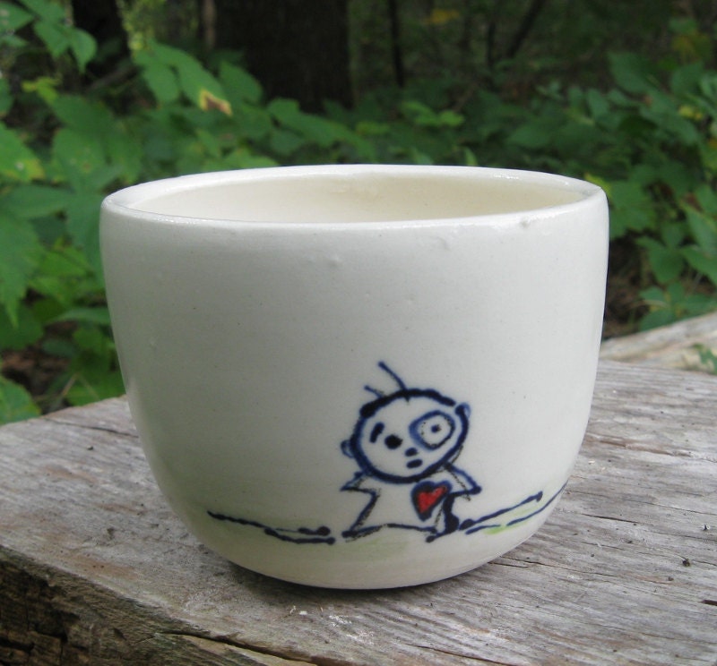 A Small Guy with a Big Red Heart on a Little White Cup