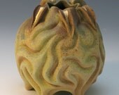 Matte green porcelain vessel with gold luster