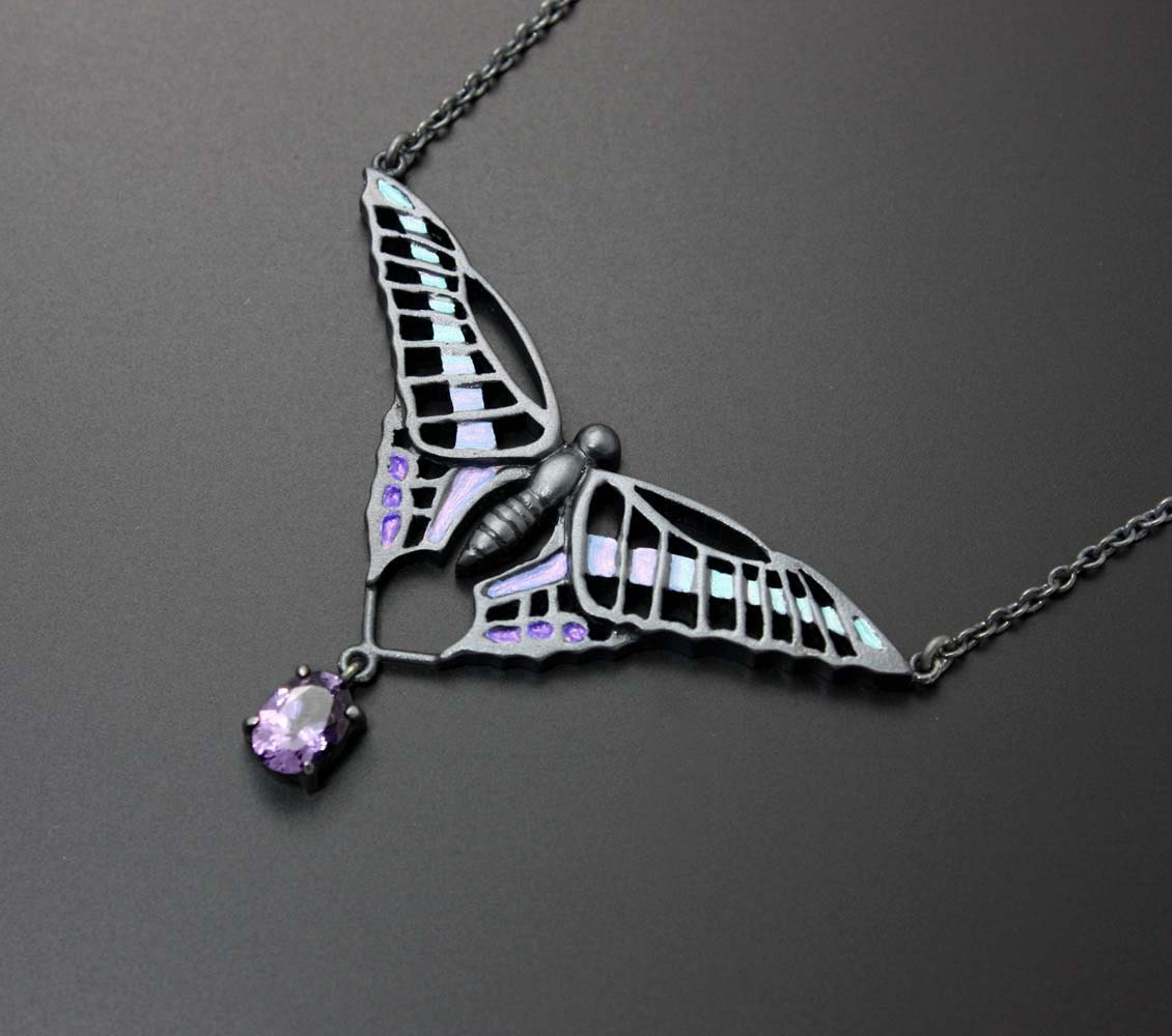 Silver necklace of a swallowtail with a violet spinel