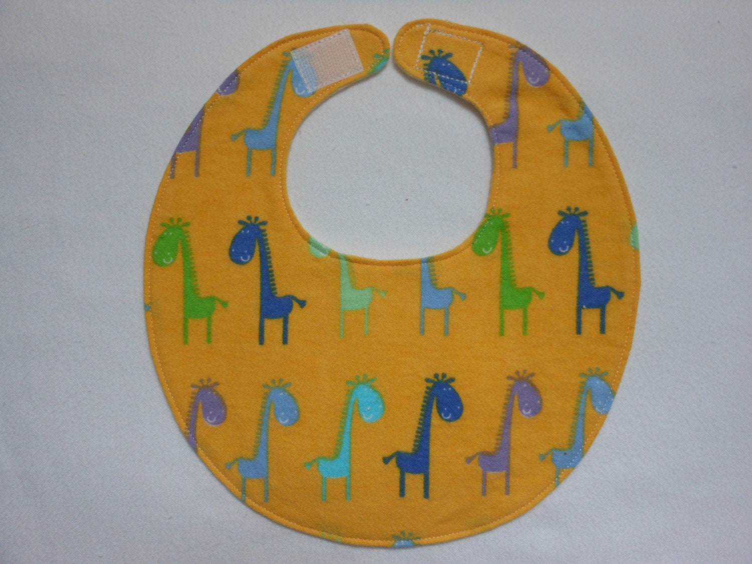 Baby Bibs, four soft layers, reversible, bright yellow with blue and green giraffes