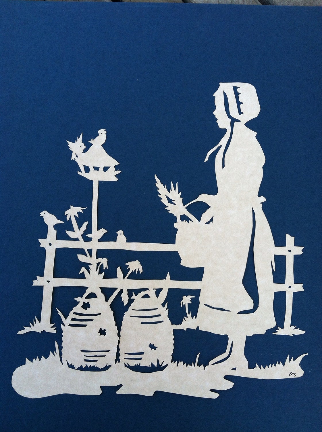 Paper cutout country girl on farm with birds and bees mounted on mat board