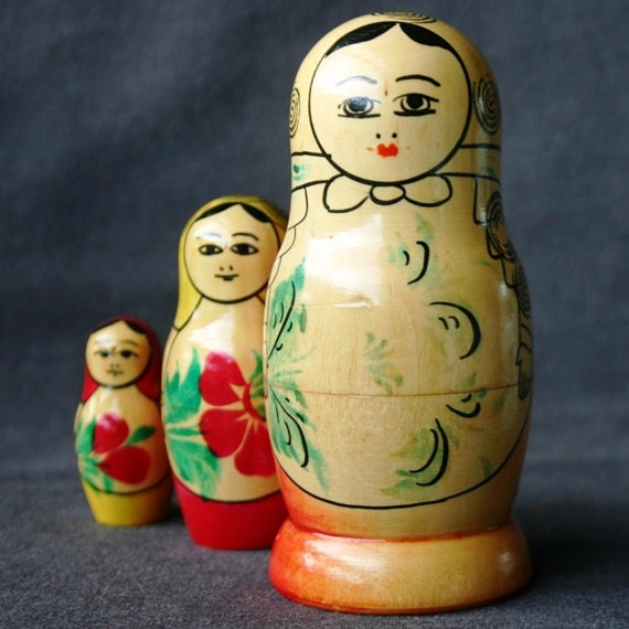 Three little vintage matryoshkas wooden dolls.