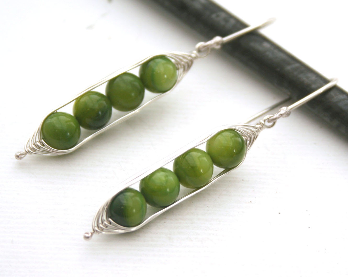 Peapod earrings. Four peas in a pod with green mother of pearl.