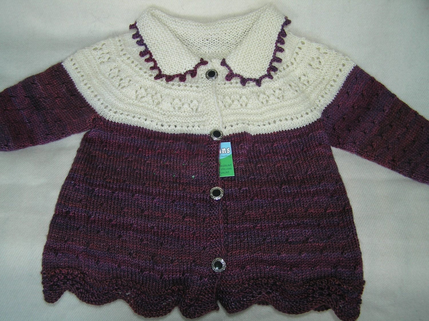 Handknitted two colour lace baby jacket
