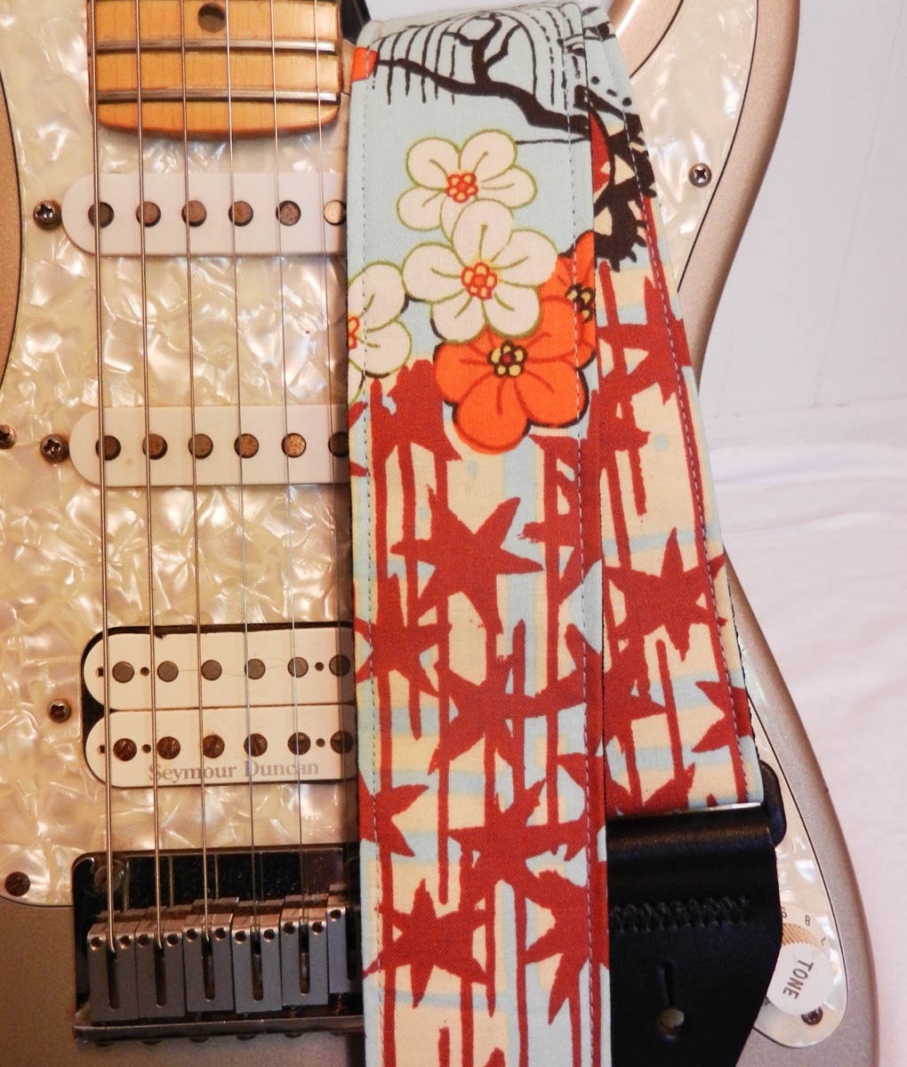 Asian inspired bright blue and red stars guitar strap