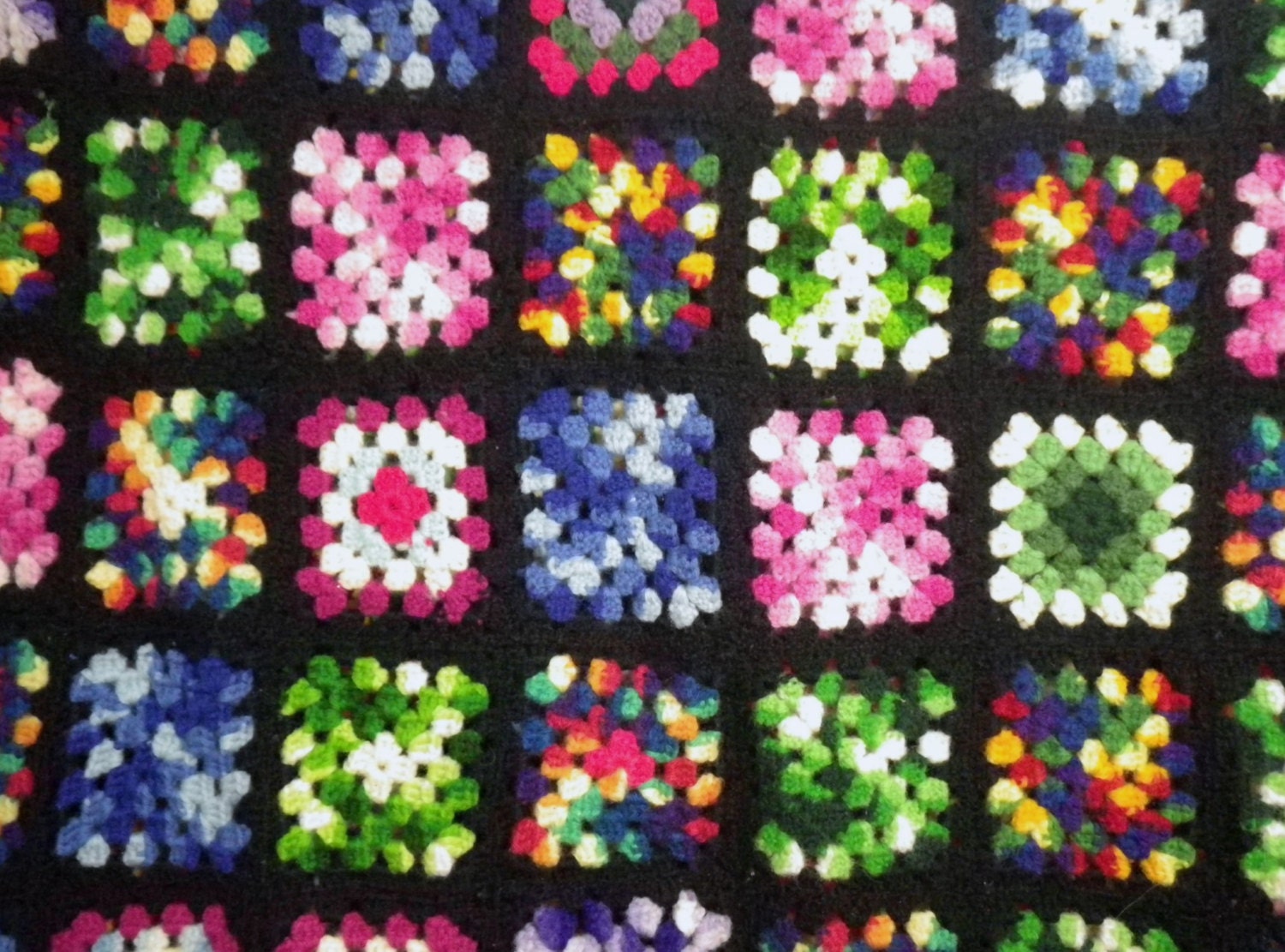Granny Square Crocheted Wool Afghan Variegated Colors on Black Background
