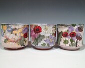 Three cups with poppies and vintage flowers