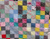 Vintage quilt top with dozens of wonderful floral and polka dot fabrics in cheerful colors