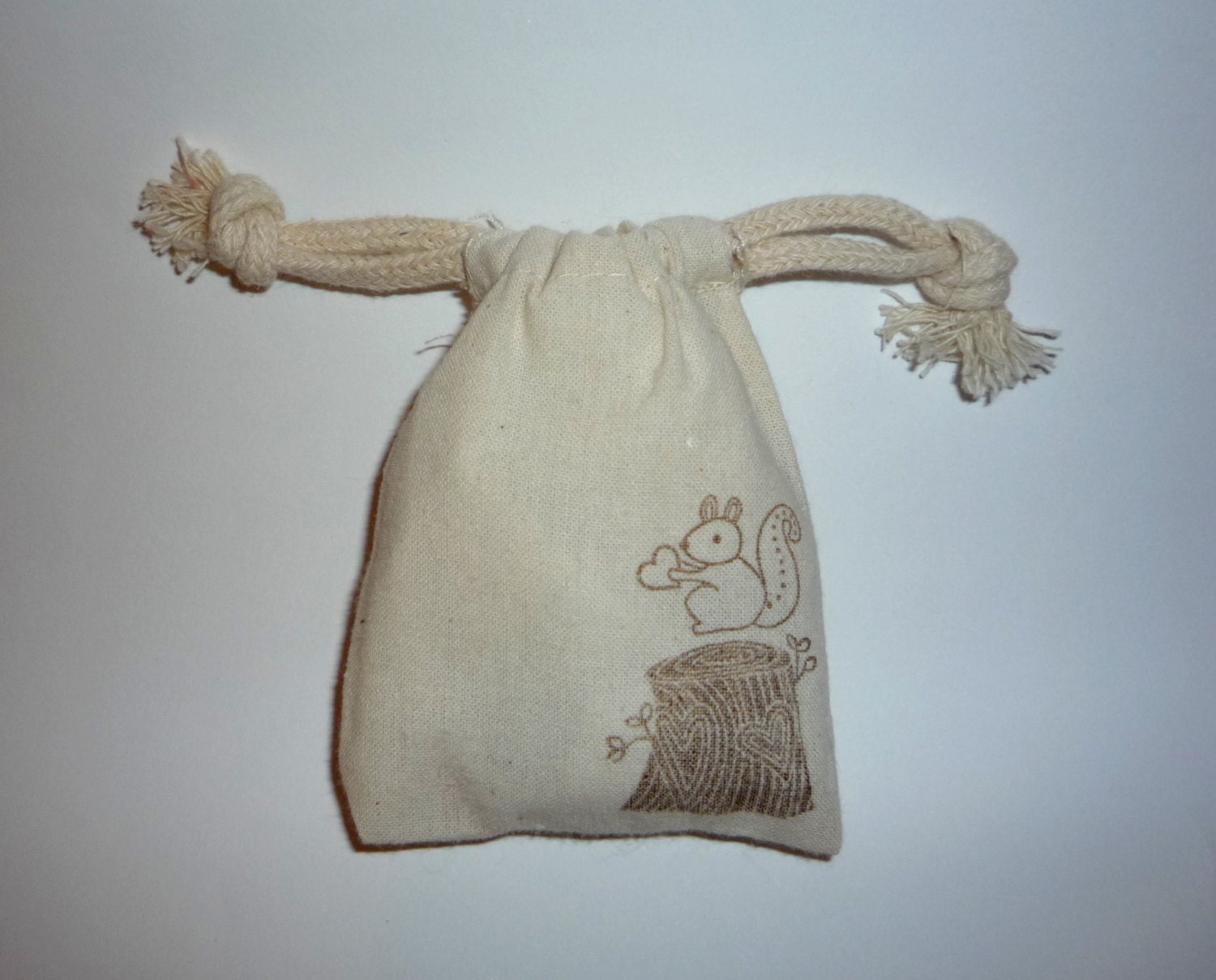 Muslin favor bag with squirrel, heart, and stump handstamped