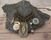 Charm Necklace featuring vintage flower, sparrow, rhinestones, typewriter key, watch face and key
