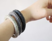 Set of 3 knitted yarn bracelets in different shades of gray