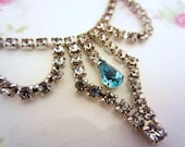 Vintage rhinestone necklace with single blue stone. Beautiful condition. Perfect for wedding, prom, special occasion wear.