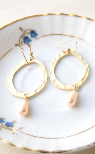 Oval gold plated dangle earrings with pearls.