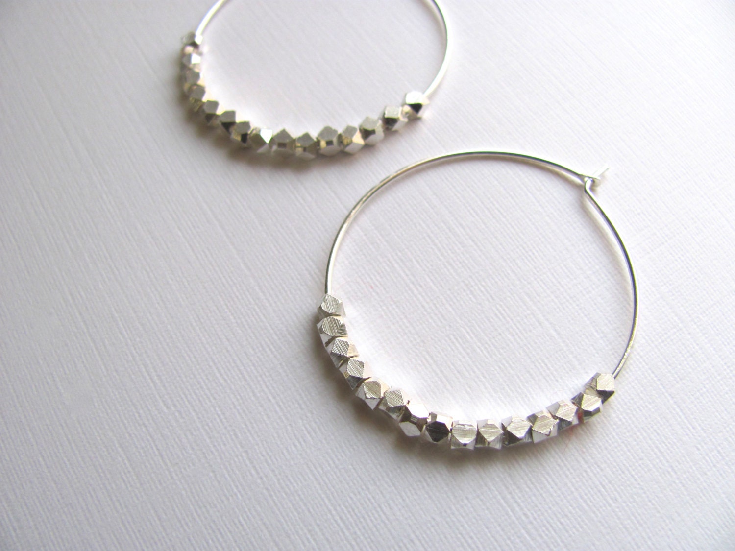 Silver hoop earrings with geometric sterling silver plated beads