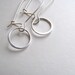 Delicate sterling silver circle drop earrings on sterling kidney fixtures, modern minimalist