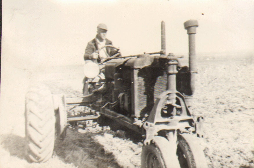 Hard at Work Vintage Photo of a Man Riding an Old Fashioned Tractor Farming