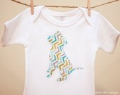Pit Bull bodysuit and bib set in aqua, green, gold and grey geometric print