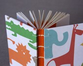 Small journal or baby shower guestbook with colorful animal print covers
