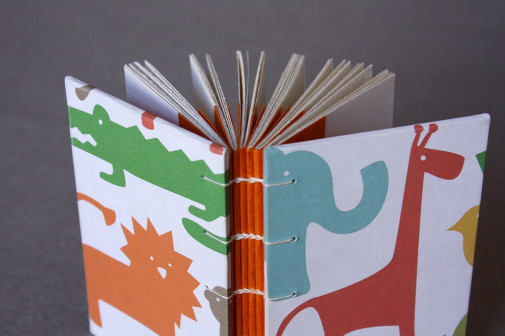 Small journal or baby shower guestbook with colorful animal print covers
