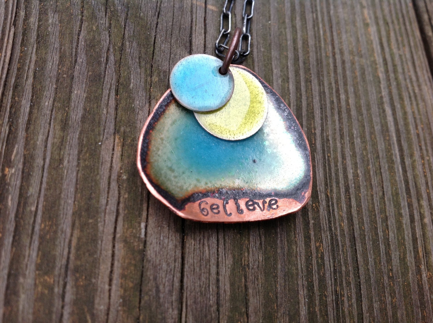 Copper necklace stamped "believe" disc with ocean blue enamel and translucent lemon yellow