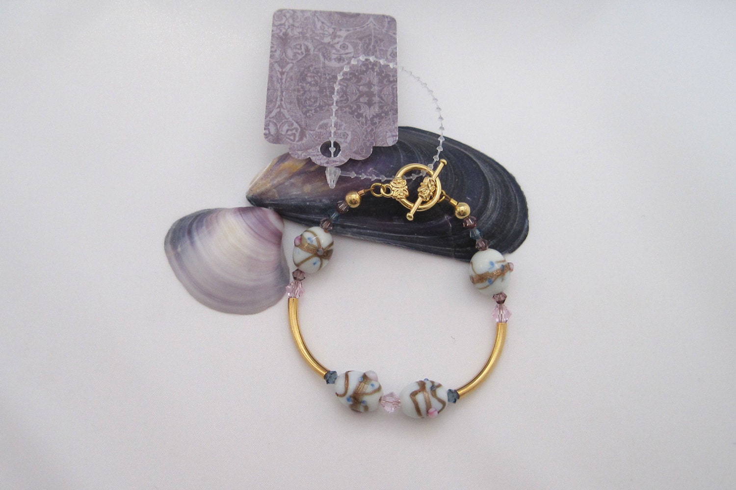 Easter Egg Bracelet - white glass beads with pink, blue and lavender dots with Swarovski crystals and gold plated tubes
