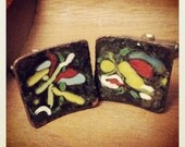 Black enameled cuff links.