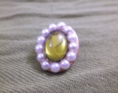 Bronze spring-green brooch with pearl halves.